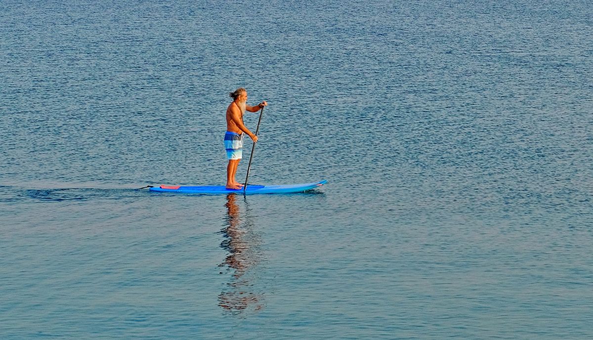 Pagayeur sur un paddle gonflable prêt à l'emploi sur l'eau – Nautiya