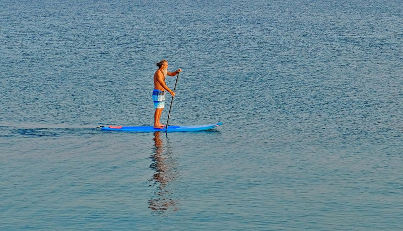Pagayeur sur un paddle gonflable prêt à l'emploi sur l'eau – Nautiya